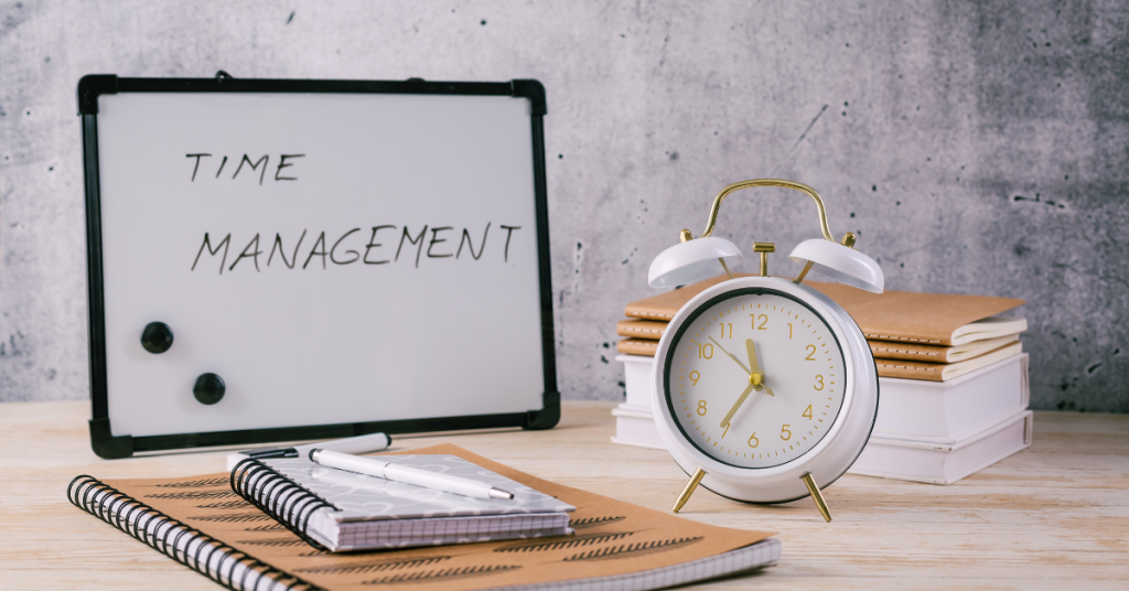 Time management tools including an alarm clock, notebooks, and a whiteboard with 'Time Management' written on it.