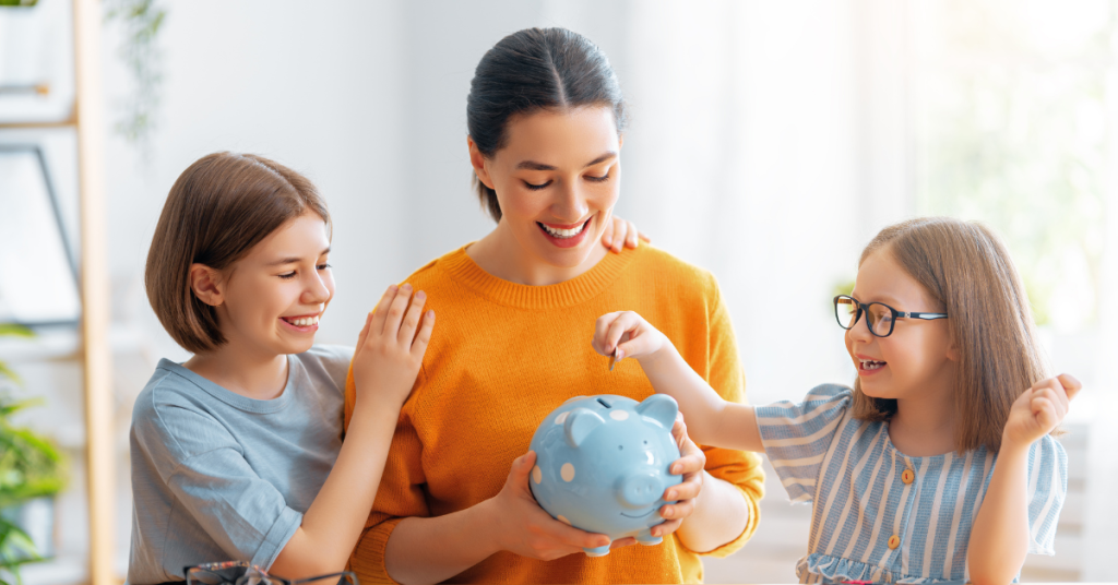 Mother and two daughters saving money with a piggy bank.